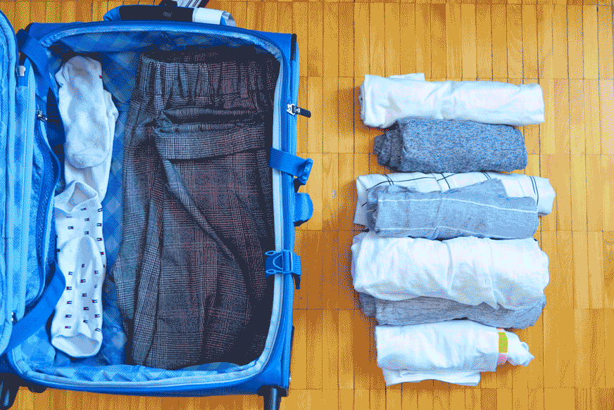 pack your suitcase with packing cubes. A gif of rolled t shirts going into a packing cube which then moves into the suitcase. It's followed by two more packed packing cubes. 