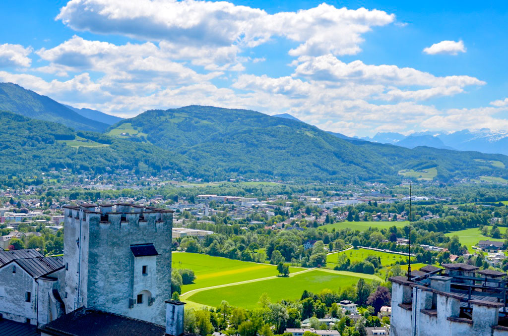 salzburg austria at the top of the castle overlooing the city with the mountains in the background a bright and sunny day