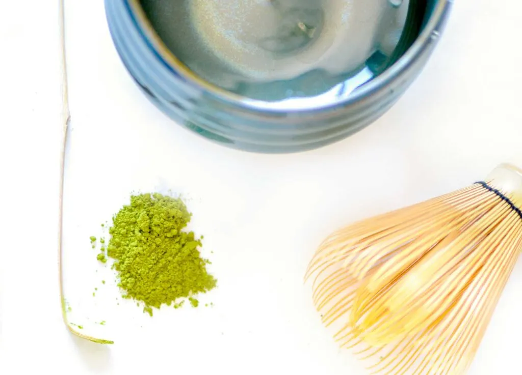 what you need to make matcha green tea. A bowl, a bamboo whisk, a bamboo scoop, and some green matcha powder