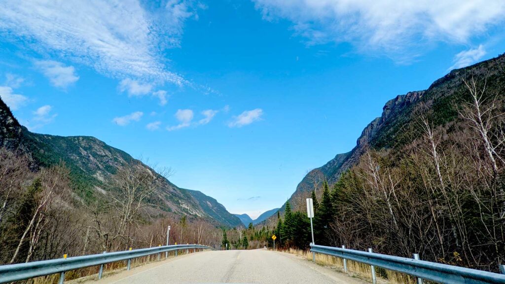 road-cutting-the-mountain-range-in-half-driving-through-quebec-national-parks