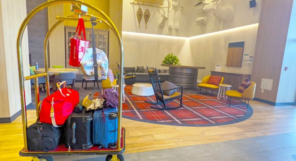 two-suitcases-two-duffel-bags-and-shopping-bags-on-a-suitcase-dolly-in-the-lobby-of-the-club-med-charlevoix