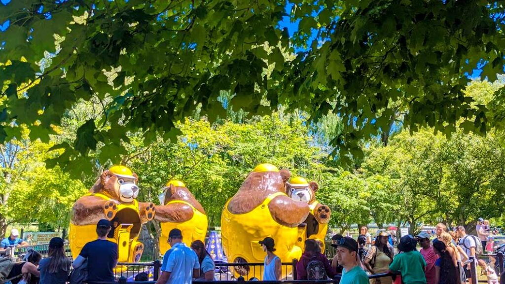 rides at centreville amusement park toronto: 4 giant (kind of scary) bears wearing yellow hats and overalls are seated around a circle. Guests can walk inside and take a seat to go around.