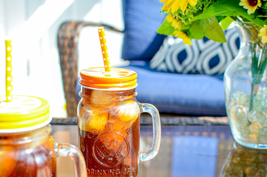 iced-tea-in-mason-jars-outside-next-to-sunflowers-