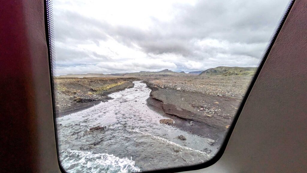 drivign-through-a-river-katla-ice-cave-Iceland