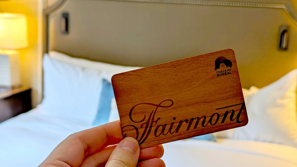 fairmont-wood-room-key-to-the-chateau-frontenac-with-a-bed-and-lamp-blurred-out-in-the-background