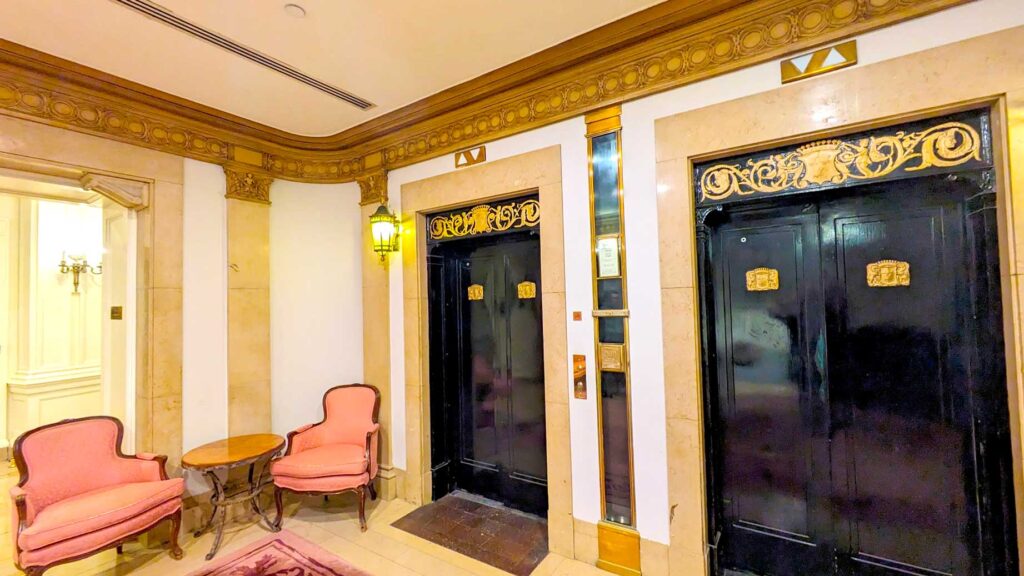 incredible-hallways-and-elevator-with-gold,-pink,-and-black-decor-at-the-chateau-frontenac