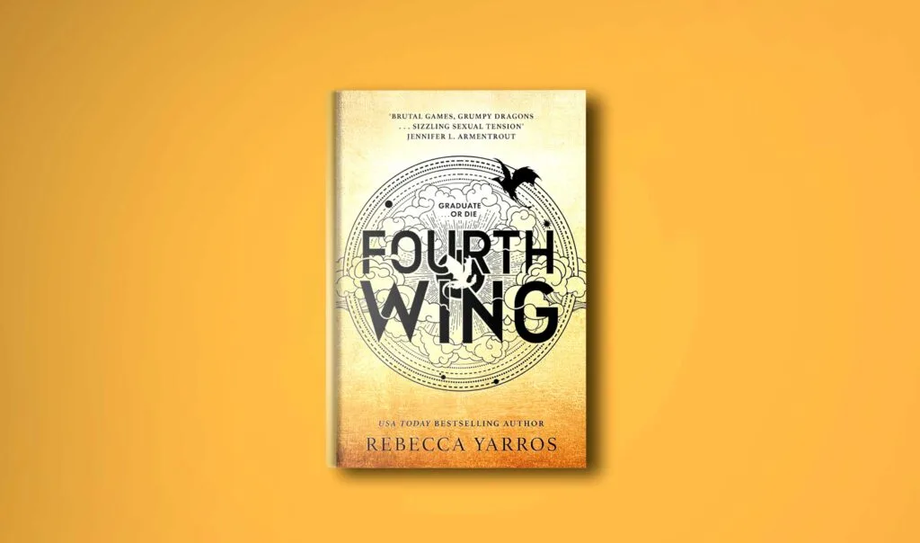 hardcover book on a plane yellow background to compliment the golden hues of  the cover of the fourth wing by rebecca yarros