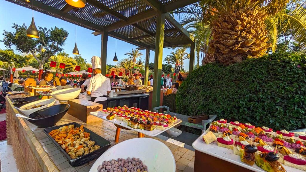 a beautiful spread of appetizer finger foods to pick at. The chef is standing on the other side of the L shaped bar, prepping some more food. It's golden hour so the sun is a rich golden hour