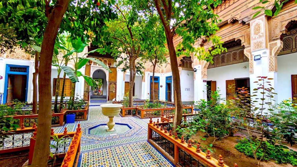 the small riad courtyard in bahia palace, the first thing you see when you walk in, four quadrants with plans in the corner and four tiled pathways leading to the centre with a small fountain in the middle. 