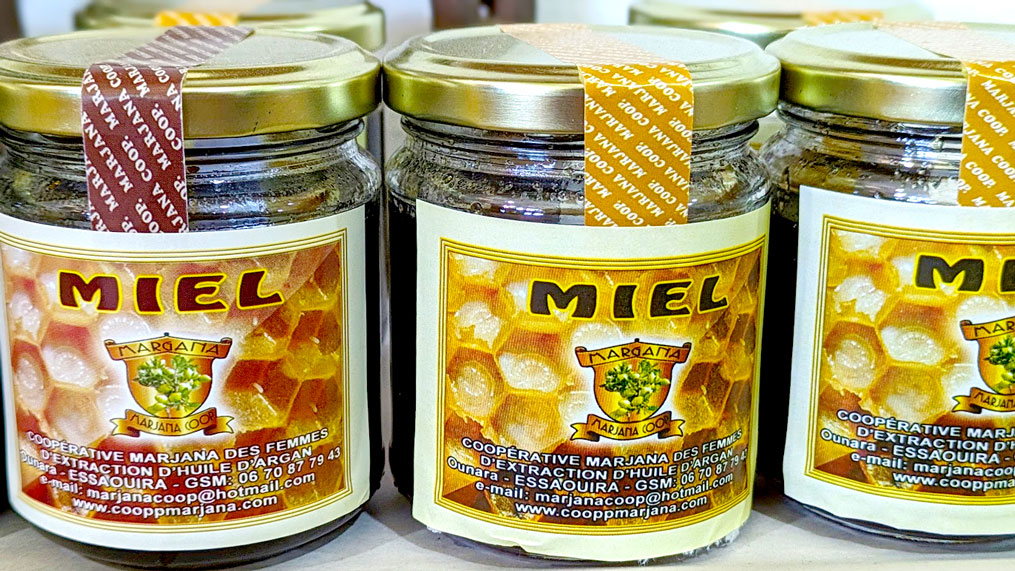 a close up of three jars of honey, but they say miel (french for honey)