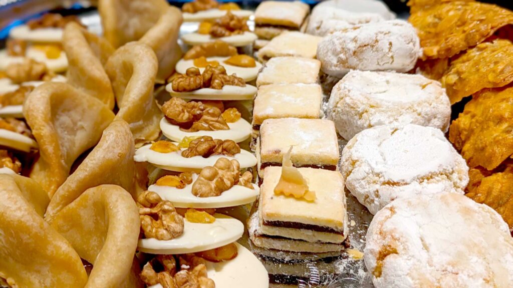 a display of delicious moroccan desserts on a tray take up the entire photo. It has 7 columns of desserts with 4 to 7 in the row, depending on the size of the dessert. 