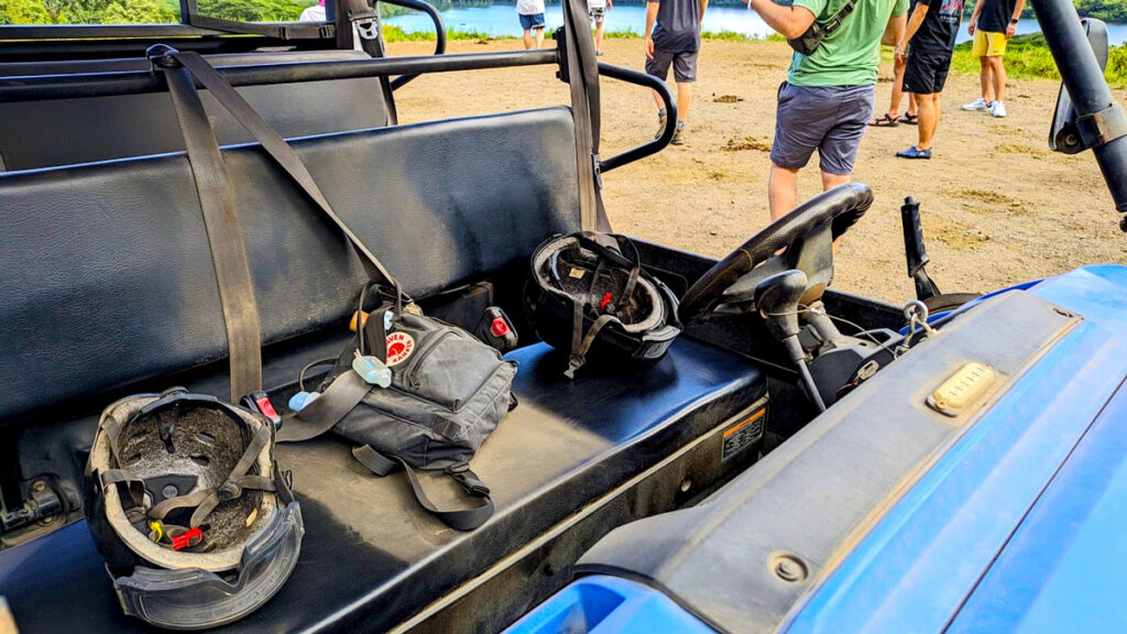 a photo showing how dirty everything gets when on the kualoa ranch utv raptor tour. This is the inside of the UTV seats. You can see the different between the black seat where the two front passengers were sitting, in between them it's a light beige colour with a bag in the middle that used to be black. 