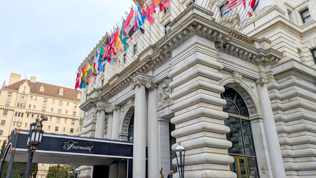 The outside of the Fairmont San Francisco. The architecture is very unique, adding a grand entrance to the hotel. On top of the entrance are the flags from around the world.