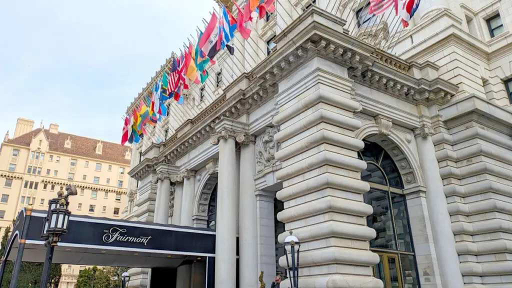 The outside of the Fairmont San Francisco. The architecture is very unique, adding a grand entrance to the hotel. On top of the entrance are the flags from around the world.