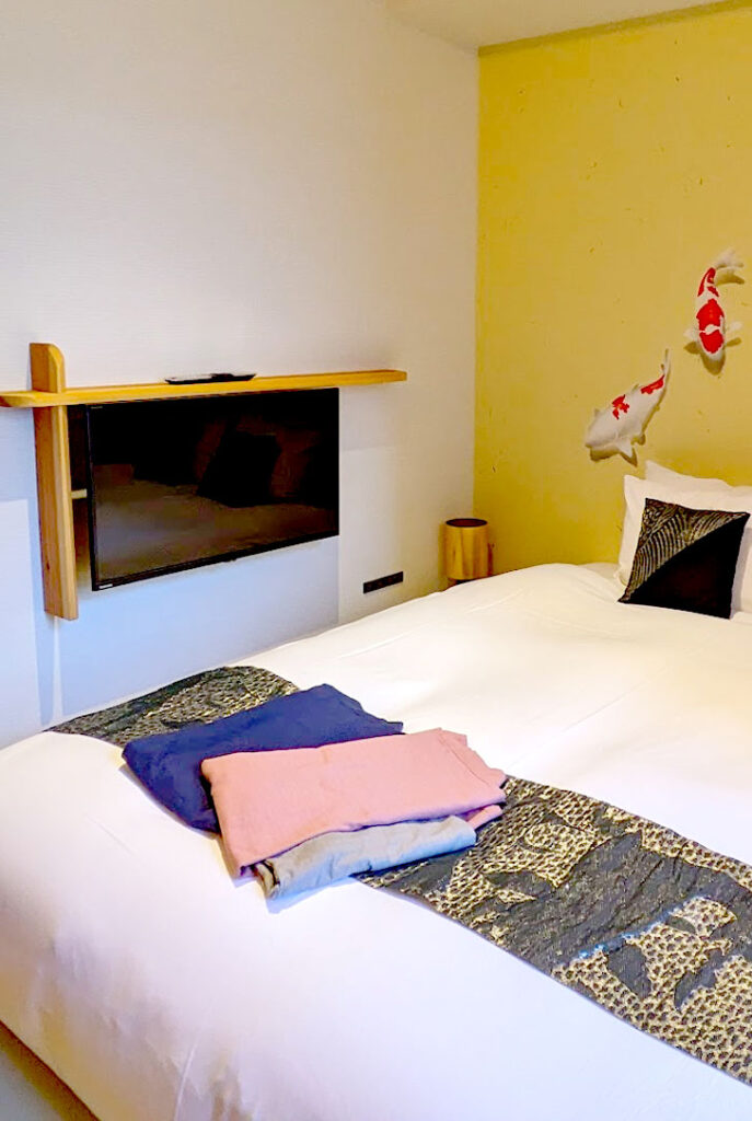 a wall unit holds a TV, but it faces the bed at the wrong angle. The bed is facing another wall so that it isn't looking at the TV from the head of the bed.